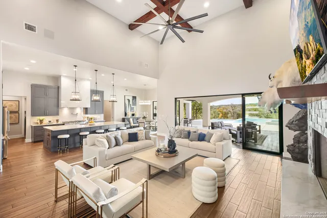 a view of a dining room with furniture a chandelier and wooden floor
