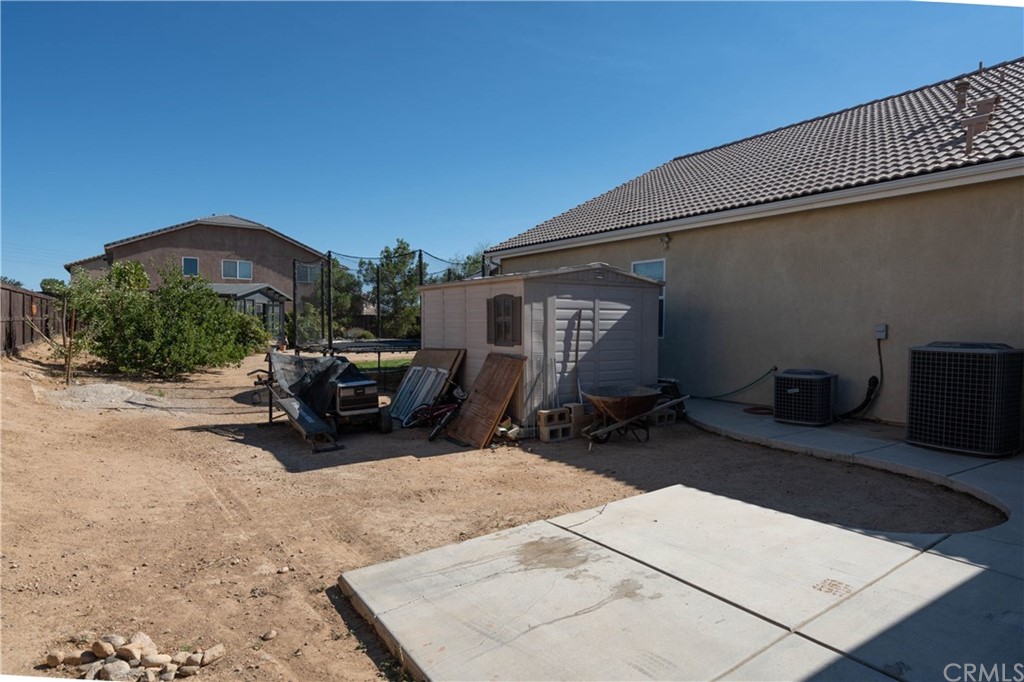 19032 Mono Drive Hesperia, CA 92345 - Photo 12 of 54 a view of a patio with table and chairs under an umbrella