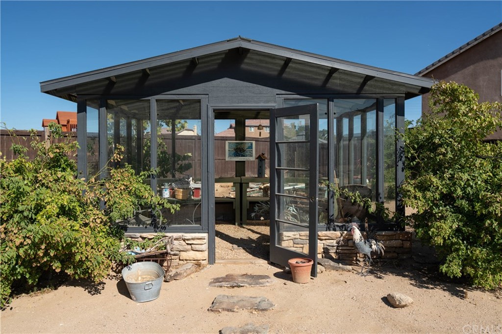 19032 Mono Drive Hesperia, CA 92345 - Photo 15 of 54 a patio with a table and chairs under an umbrella
