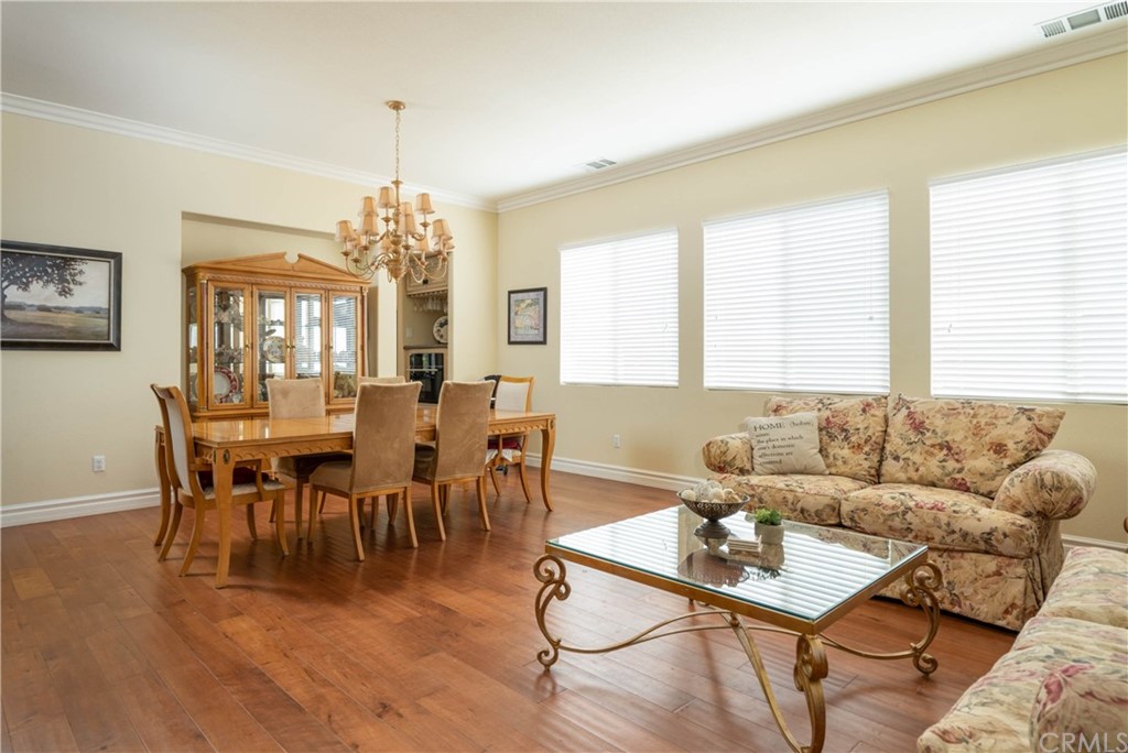 19032 Mono Drive Hesperia, CA 92345 - Photo 32 of 54 a living room with furniture a dining table and a chandelier