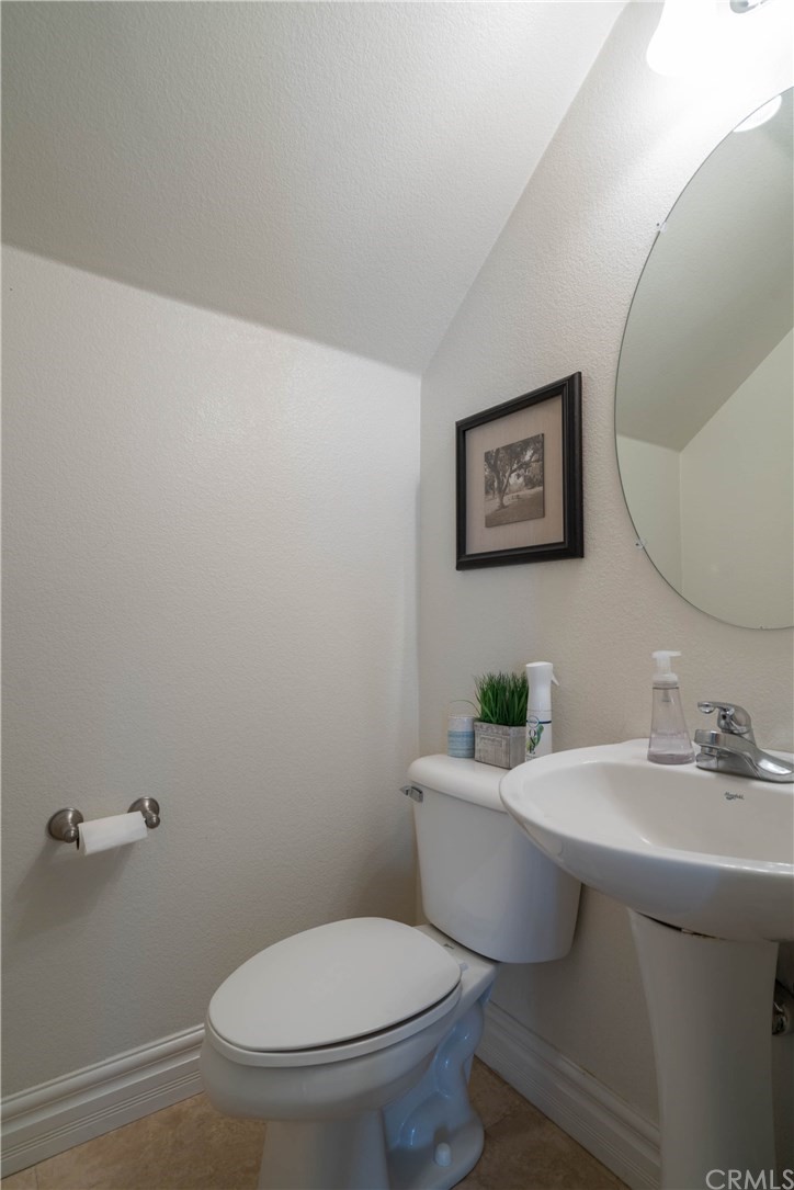 19032 Mono Drive Hesperia, CA 92345 - Photo 36 of 54 a bathroom with a toilet a sink and mirror