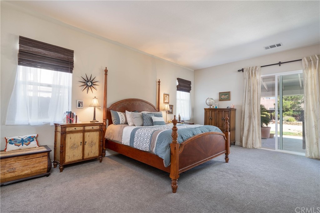 19032 Mono Drive Hesperia, CA 92345 - Photo 37 of 54 a spacious bedroom with a bed and a cabinets