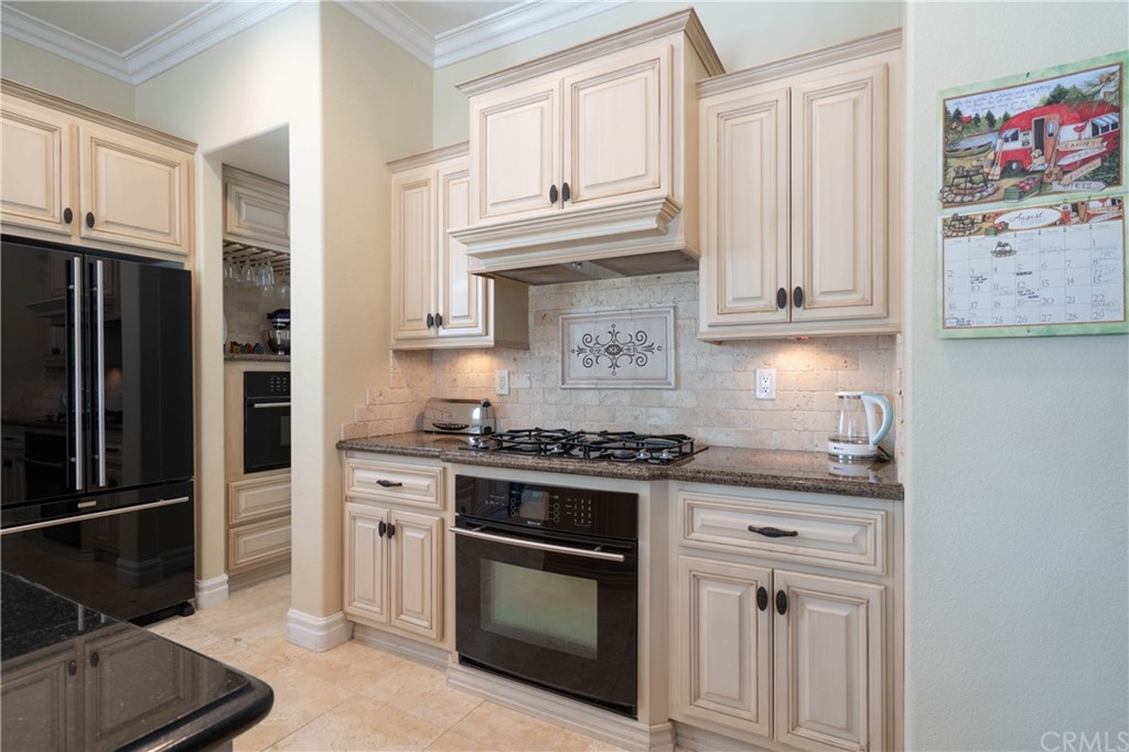 19032 Mono Drive Hesperia, CA 92345 - Photo 51 of 54 a kitchen with stainless steel appliances granite countertop a stove a refrigerator and a cabinets