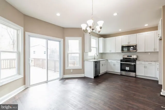 a view of a kitchen with a sink stainless steel appliances