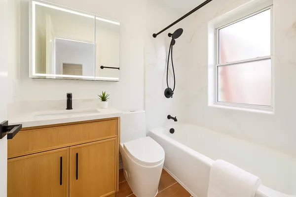 a bathroom with a sink toilet and shower