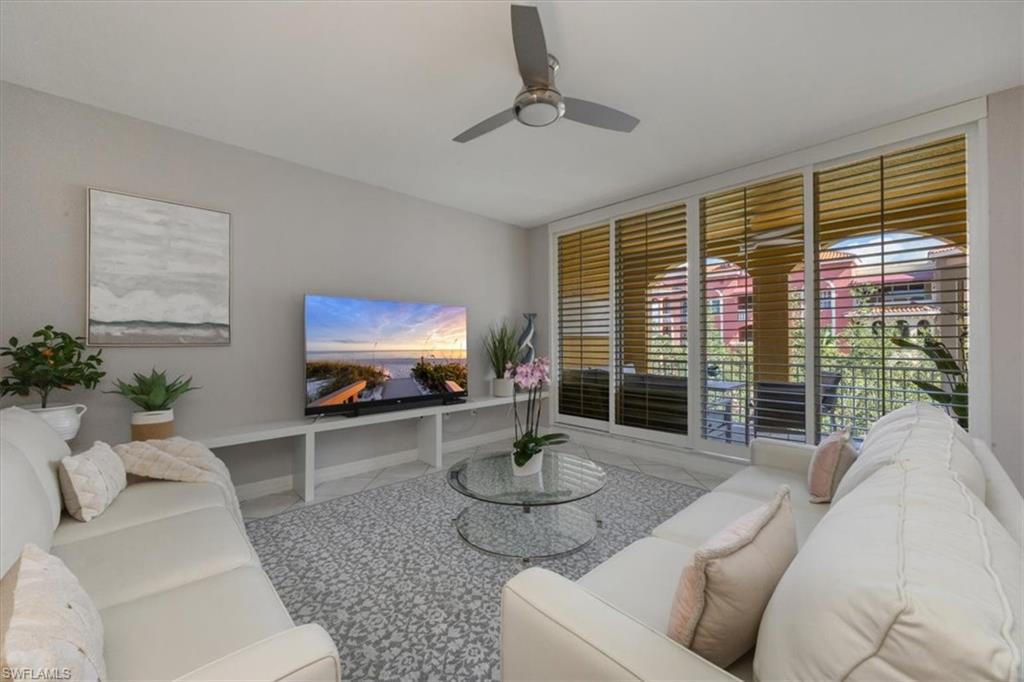 410 Bayfront Place, Unit 2403 Naples, FL 34102 - Photo 1 of 20 a living room with furniture and a floor to ceiling window