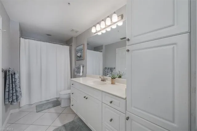a spacious bathroom with a granite countertop sink a mirror and a shower