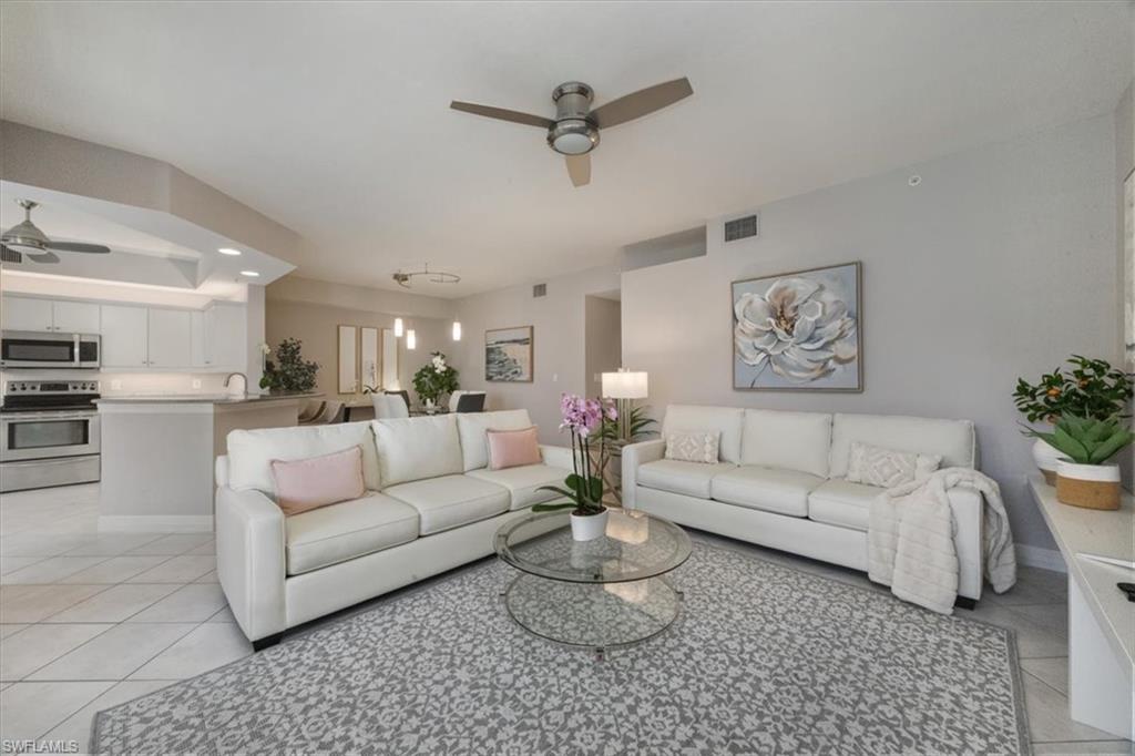 410 Bayfront Place, Unit 2403 Naples, FL 34102 - Photo 2 of 20 a living room with furniture a rug and a ceiling fan