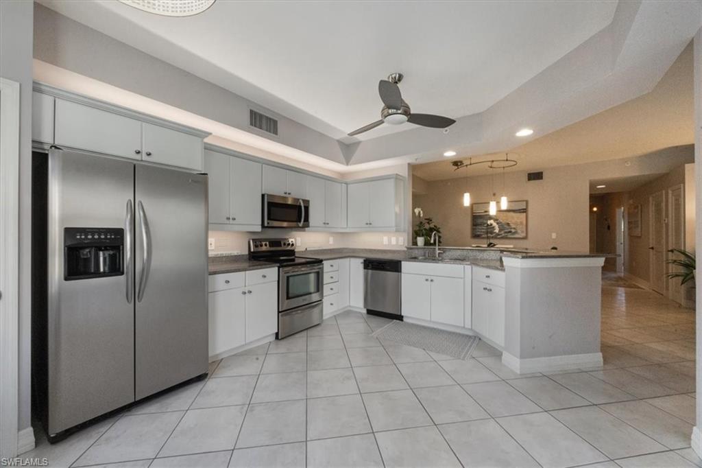410 Bayfront Place, Unit 2403 Naples, FL 34102 - Photo 4 of 20 a large kitchen with a large counter top stainless steel appliances and cabinets