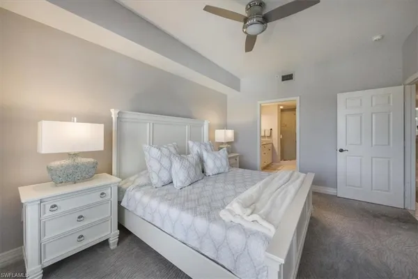 a bedroom with a bed and a night stand