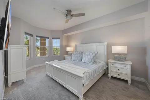 a bedroom with a bed lamp and window