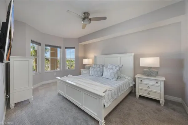 a bedroom with a bed lamp and window