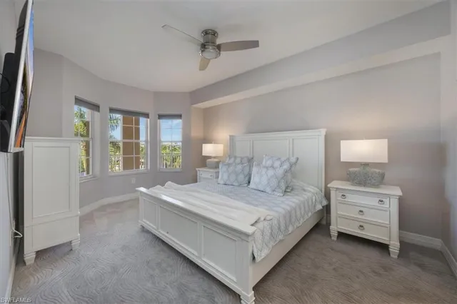 a bedroom with a bed lamp and window