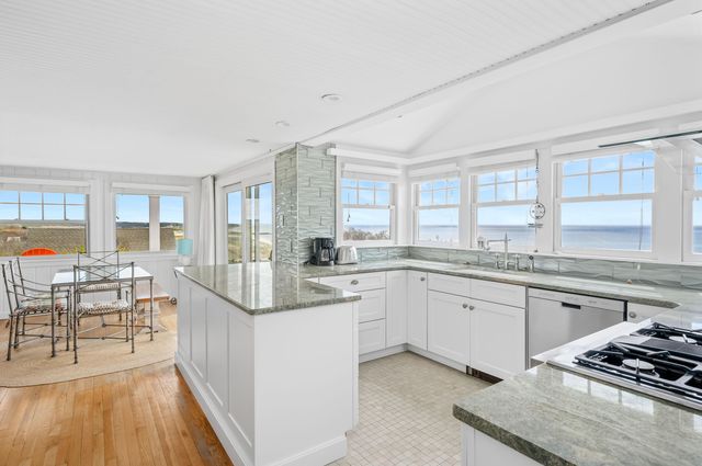 a kitchen with stainless steel appliances granite countertop a stove sink and cabinets