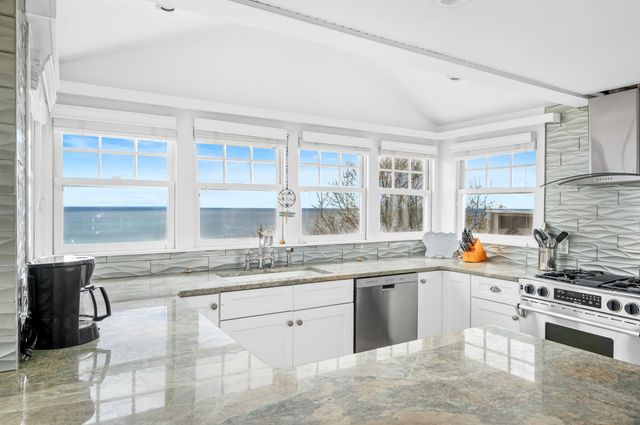 a kitchen with granite countertop cabinets stainless steel appliances and a counter space