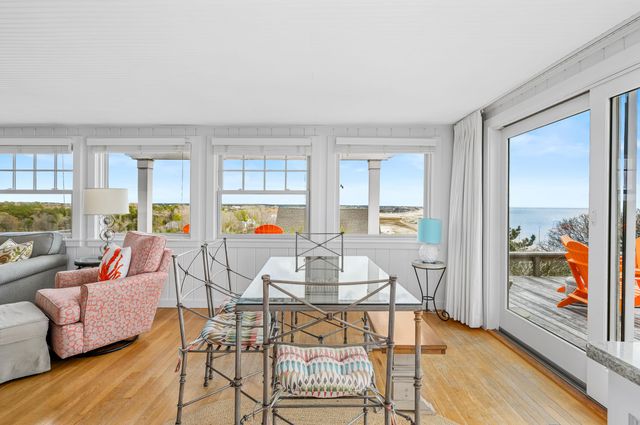 a living room with dining table and a table