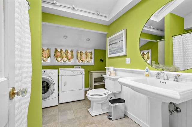 a bedroom with a bed a chair and a window