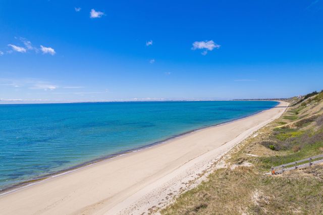 an aerial view of residential houses with outdoor space and seating
