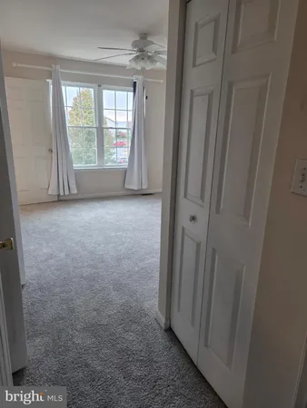 a view of an empty room with a ceiling fan