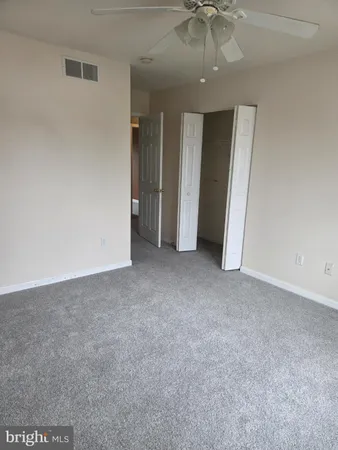 a white toilet sitting next to a shower curtain