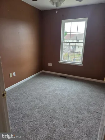 a bathroom with a toilet and a shower curtain