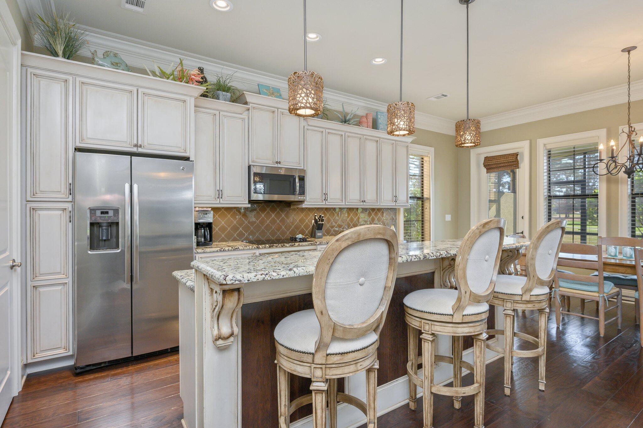 1881 Baytowne Loop Miramar Beach, FL 32550 - Photo 7 of 60 a kitchen with stainless steel appliances kitchen island granite countertop a kitchen island hardwood floor and a sink