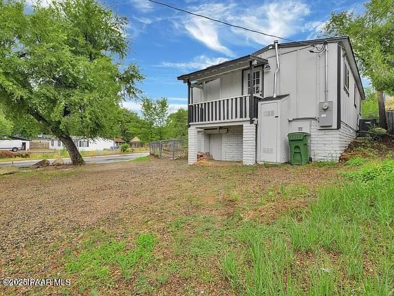 415 Comfort Avenue Prescott, AZ 86301 - Photo 1 of 10 a white house that has tree in front of it