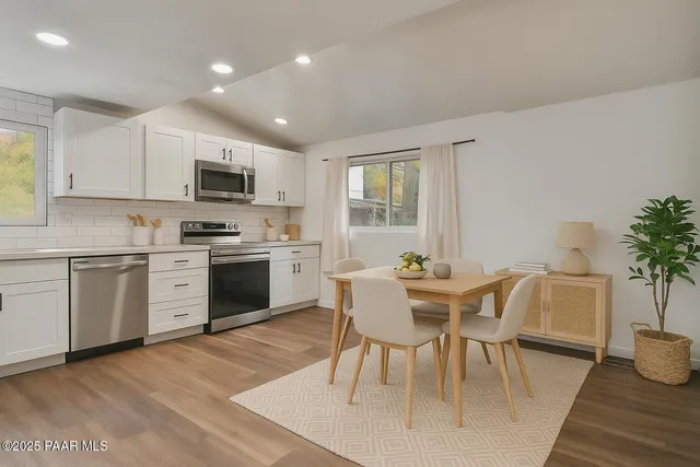 a view of kitchen with cabinets table and chairs