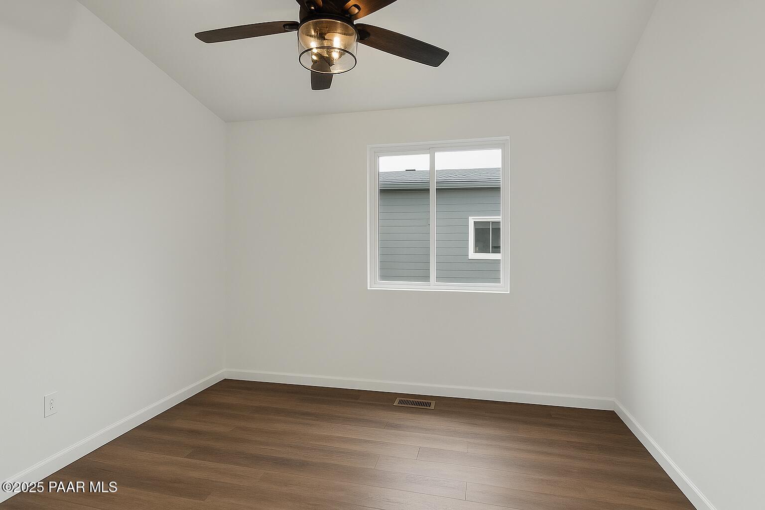 415 Comfort Avenue Prescott, AZ 86301 - Photo 5 of 10 an empty room with wooden floor chandelier fan and windows