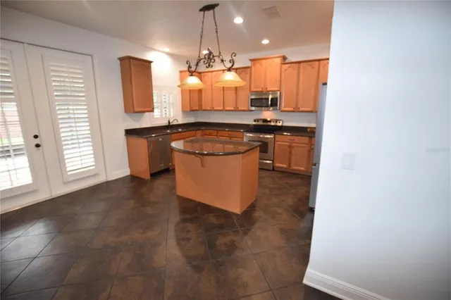 a kitchen with a sink cabinets and stainless steel appliances
