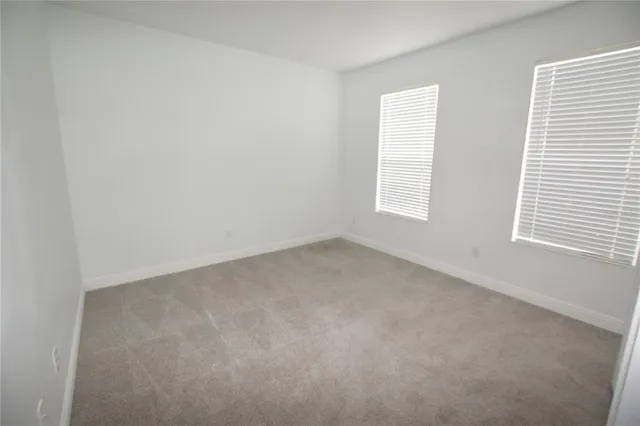 a view of an empty room and a window