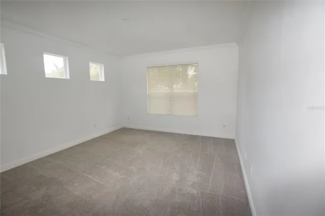 an empty room with windows and closet