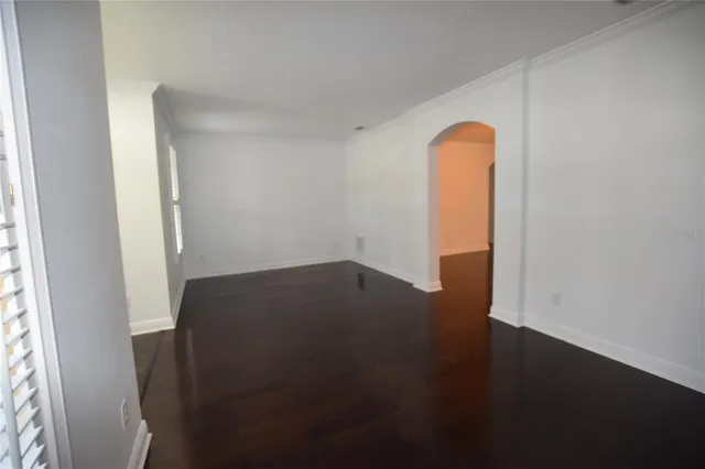 an empty room with wooden floor and closet
