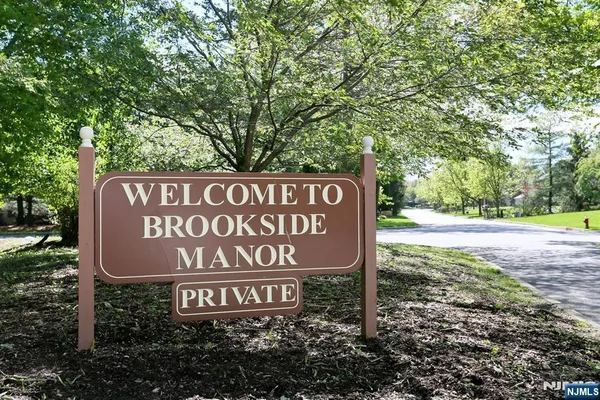 a sign broad in front of the red tree