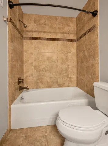 a bathroom with a toilet and a bath tub
