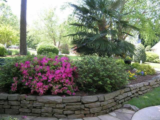 2913 Tillinghast Trail Raleigh, NC 27613 - Photo 12 of 12 As you leave the home, you will see this stone wall and walkway with such nice landscaping. Yes, that actually is a palm tree! Other