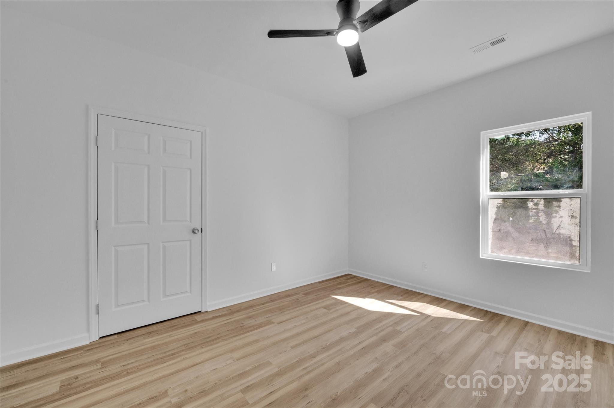 504 Christopher Lane Chester, SC 29706 - Photo 11 of 18 an empty room with wooden floor chandelier fan and windows