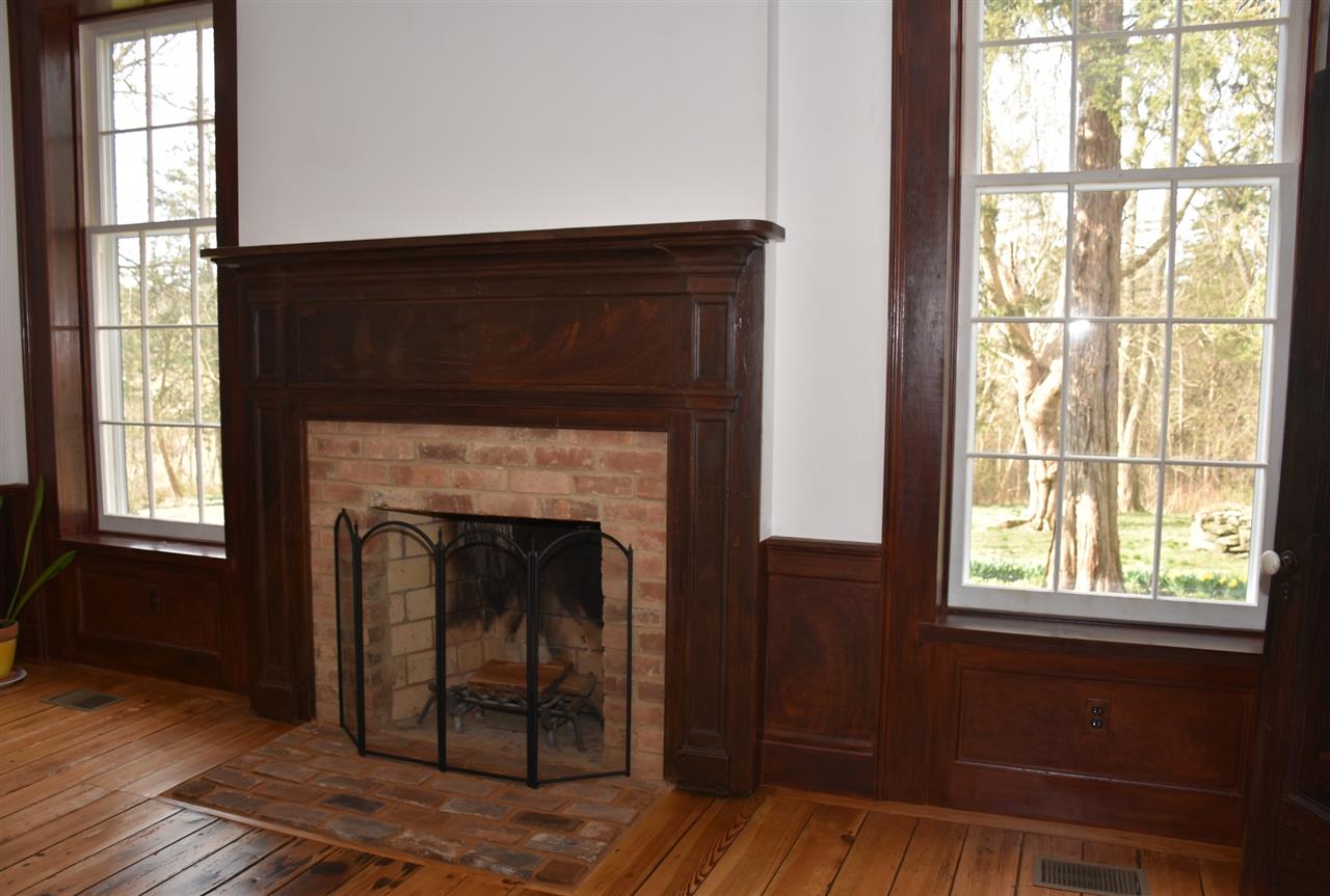 568 Whetstone Draft Road Mount Solon, VA 22843 - Photo 13 of 49 a living room with a fireplace and windows