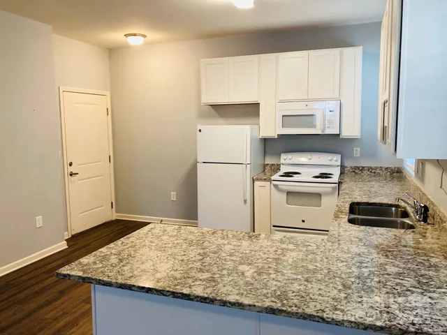 a kitchen with a stove and a refrigerator