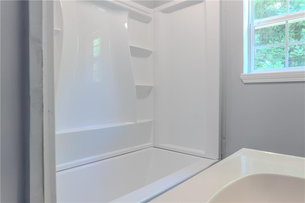 53 Washington Drive Forsyth, GA 31029 - Photo 11 of 19 a bathroom with a bathtub and a shower
