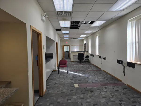 a hallway with furniture and a flat screen tv