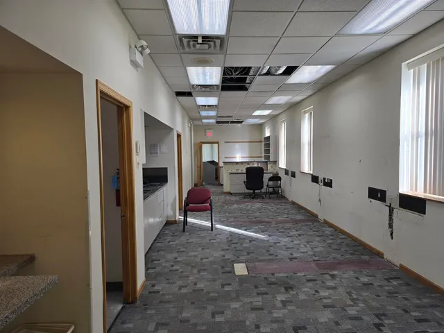 a hallway with furniture and a flat screen tv