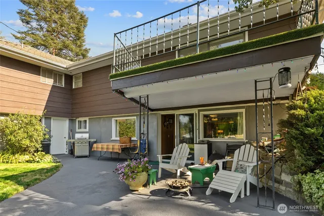 a front view of a house with outdoor seating and a potted plant