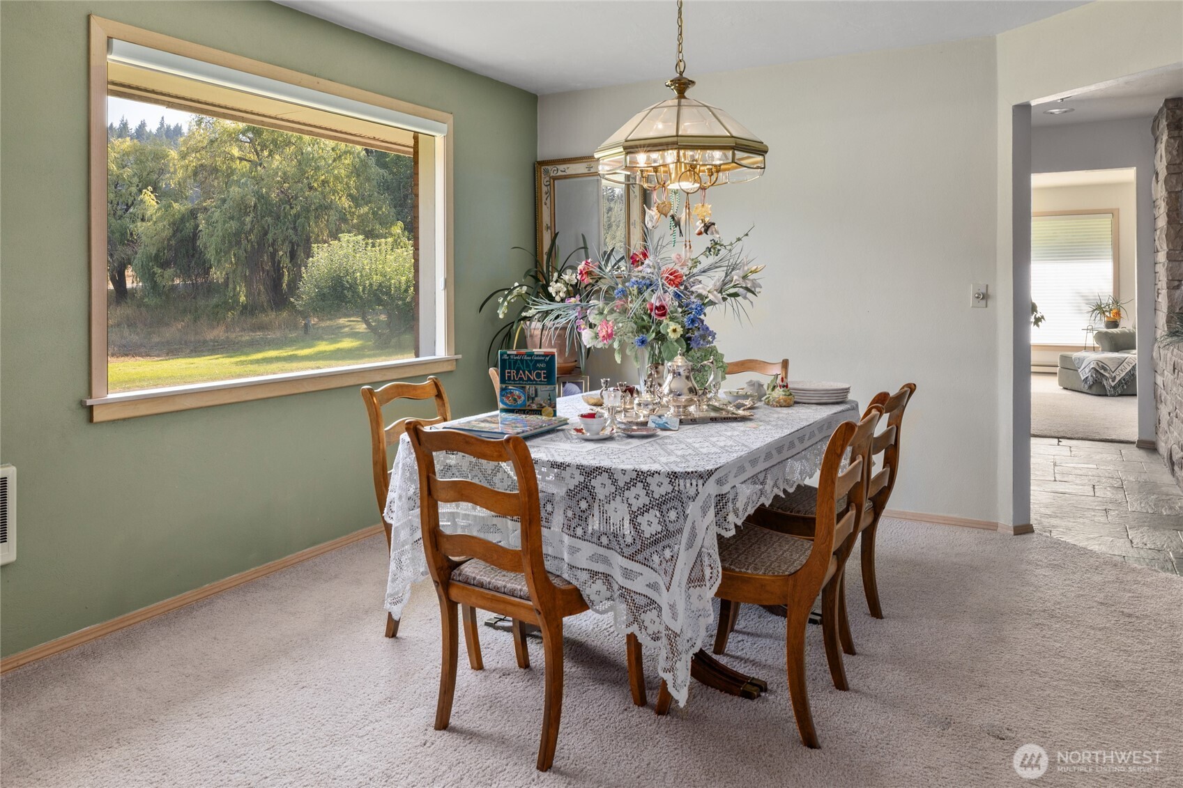 911 Westside Road Cle Elum, WA 98922 - Photo 8 of 40 a dining room with furniture a chandelier and a rug