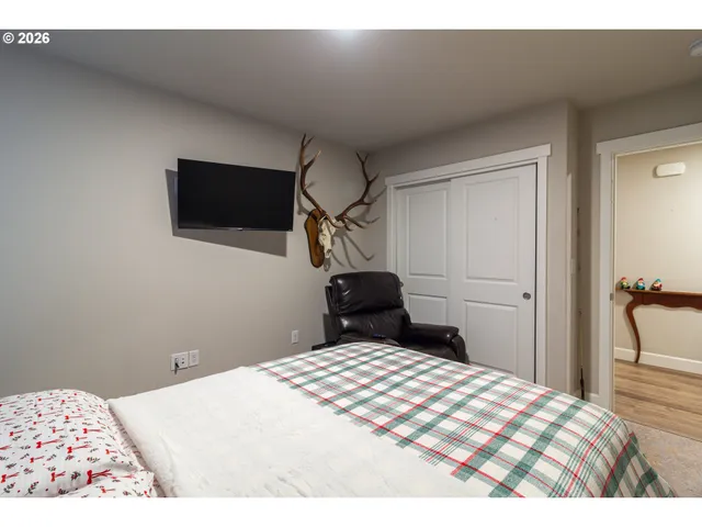 a bedroom with a bed and a flat screen tv
