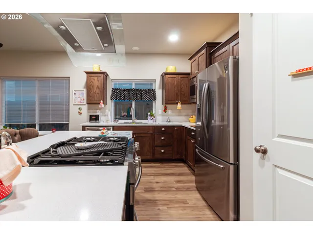 a kitchen with stainless steel appliances a refrigerator sink and stove