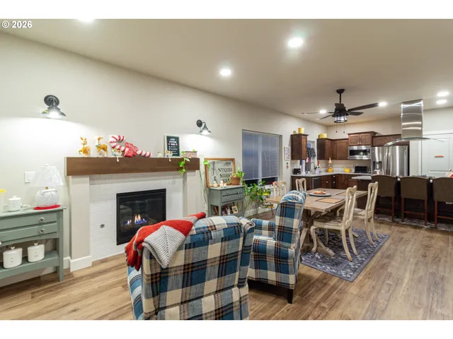 a living room with furniture a fireplace and kitchen view