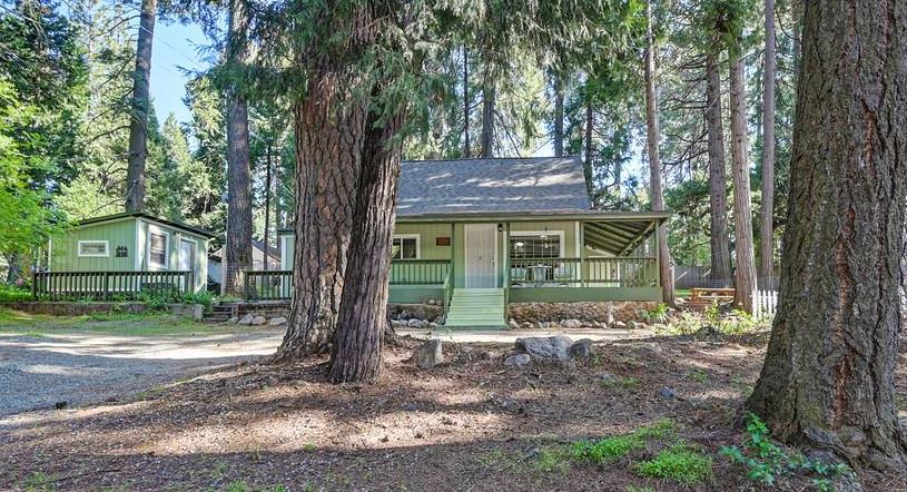 6252 Pony Express Trail Pollock Pines, CA 95726 - Photo 1 of 43 a view of a house with a yard and large tree