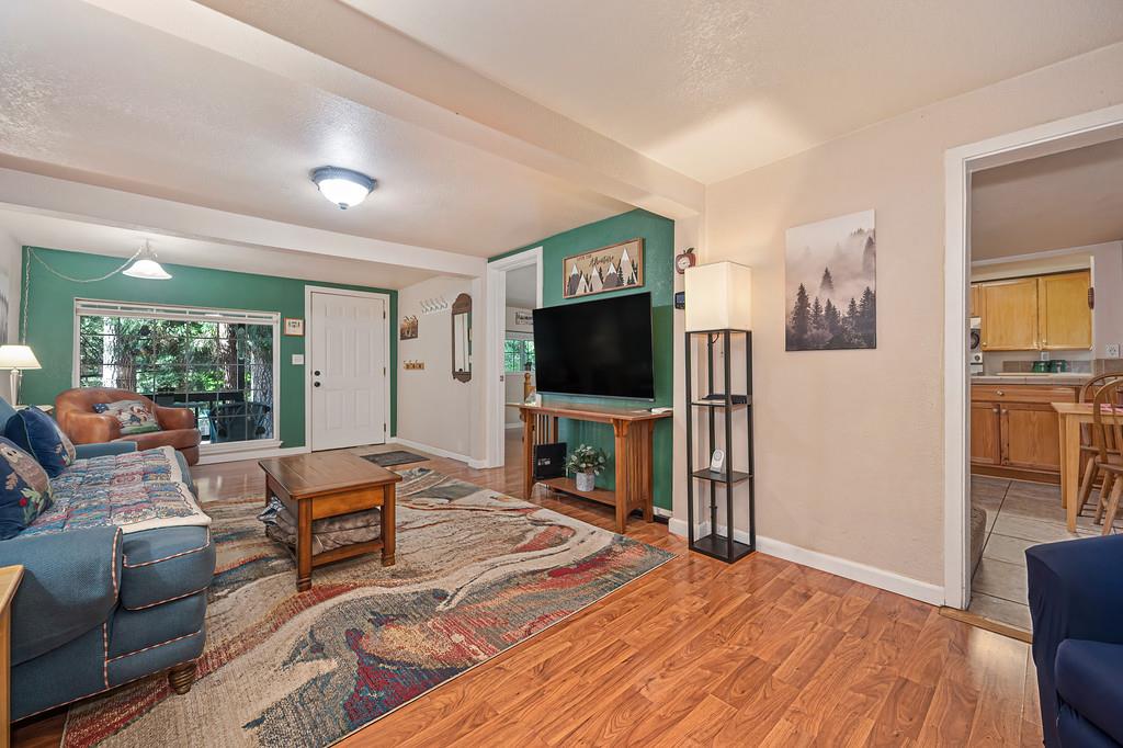 6252 Pony Express Trail Pollock Pines, CA 95726 - Photo 15 of 43 a bedroom with furniture and a flat screen tv