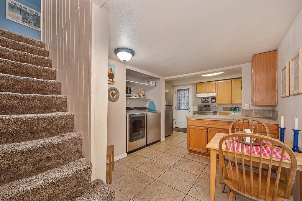 6252 Pony Express Trail Pollock Pines, CA 95726 - Photo 16 of 43 a kitchen with stainless steel appliances granite countertop a stove a sink and a refrigerator